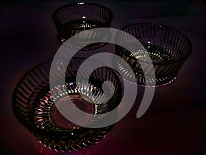 Glass bowls isolated in dark background.