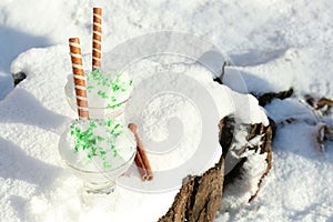 Glass bowls with tasty ice cream and waffle rolls