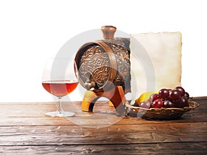 Glass of brandy, barrel, old paper on a white background