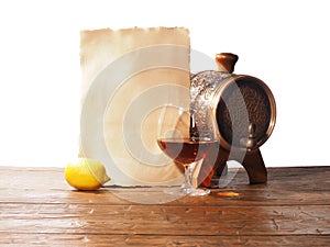 Glass of brandy, barrel, old paper on a white background