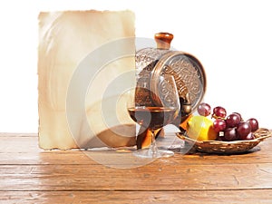 Glass of brandy, barrel, old paper on a white background