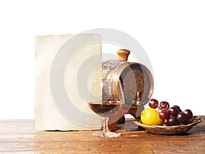 Glass of brandy, barrel, old paper on a white background