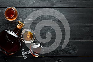 A glass of brandy on a black background. Top view.