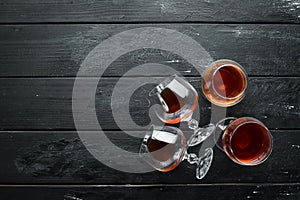 A glass of brandy on a black background. Top view.