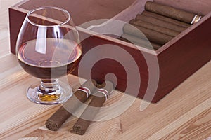 Glass of brandy and cigars photo