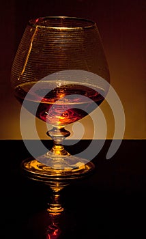 Glass with brandy in dark