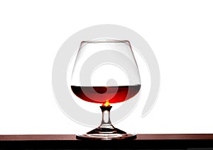 Glass with brandy on a white background