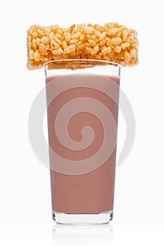 Glass of breakfast chocolate milk with cereal bar