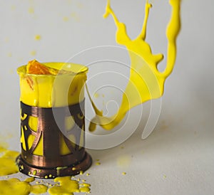 a glass with a bright liquid and flying splashes