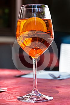 A glass with bright orange liquid, Spritz Aperol cocktail