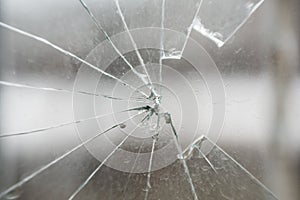 Glass broken by hooligans in a metal-plastic window, close-up