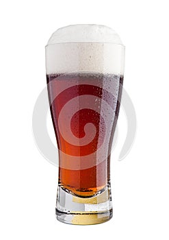 Glass of brown ale beer with foam isolated