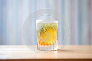 glass with bubbled texture, condensation, cocktail inside