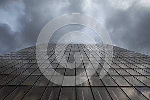 Glass building and stormy cloudy sky