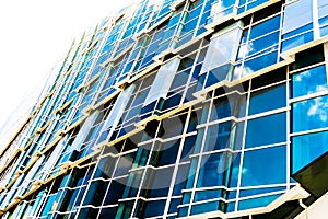 Glass business office building facade, reflection of the sky, exterior of skyscraper