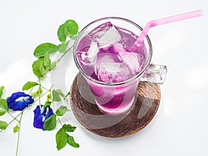 Glass of butterfly pea flower juice on white background