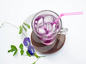 Glass of butterfly pea flower juice on white background