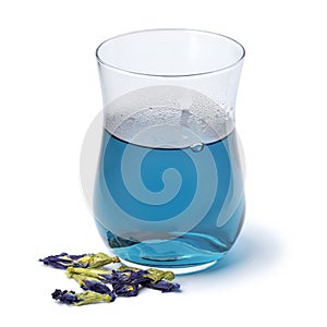 Glass with Butterfly pea flower tea and dried butterfly pea tea flowers close up