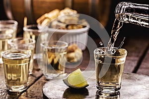 Glass of CachaÃ§a, pinga, cana or caninha is the sugar cane brandy, typical drink from Brazil, drops of drink flying, spilling or