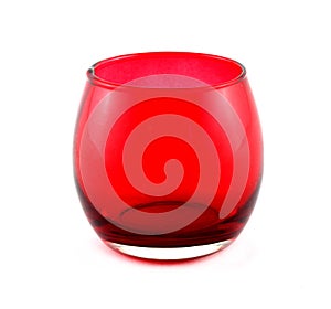 Glass candle holder in Christmas decor. It has red colour