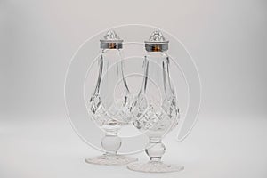 Glass candleholders on a grey background