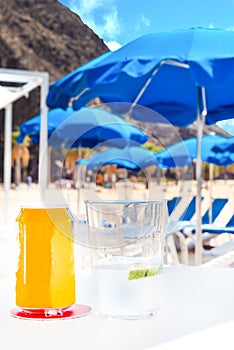 Glass and cane of a soda drink on a beach bar table, in Tenerife. Canary Islands