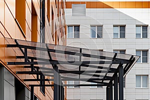 Glass canopy to protect from precipitation at the entrance to a modern office building