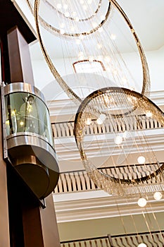 Glass capsule elevator in the hall at luxury hotel