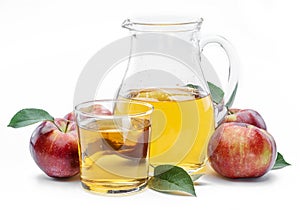 Glass and carafe of fresh apple juice and organic apples isolated on white background