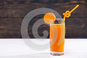 Glass of carrot juice full of vitamins with straw