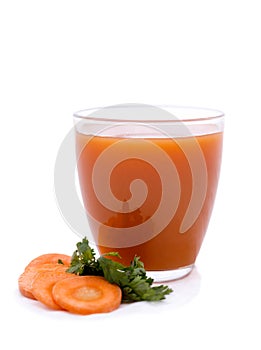 Glass of carrot juice with vegetable slices with vegetables isolated