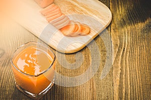 glass of carrot juice on a wooden background/glass of carrot juice on a wooden background. With copy space. Top view