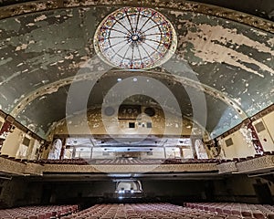 Glass ceiling and old chairs in the theater hall in the abandoned Irem Shrine in Pennsylvania, USA