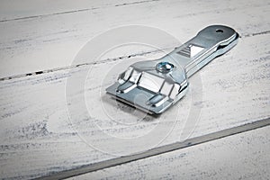 Glass ceramic scraper on a white wooden background