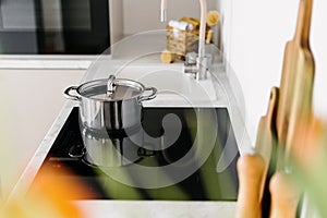 Glass ceramic stove with shiny metal pot on top