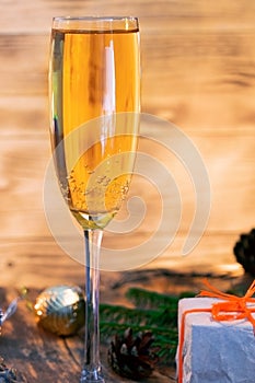 A glass of champagne.Bubbly. A goblet of Sparkling wine. A wineglass of Fizz. Christmas background. A candle champagne