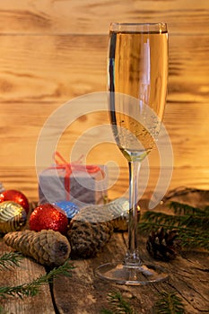 A glass of champagne.Bubbly. A goblet of Sparkling wine. A wineglass of Fizz. Christmas background. A candle champagne