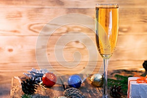 A glass of champagne.Bubbly. A goblet of Sparkling wine. A wineglass of Fizz. Christmas background. A candle champagne