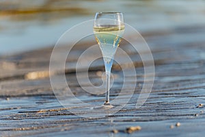 A glass of champagne or cava on vacation, low tide on Dunes Corralejo sandy beach, Fuerteventura, Canary islands