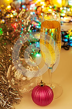 Glass of champagne and christmas decorations