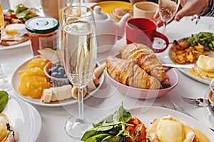 Glass of champagne close-up on the table with different breakfast and brunch dishes