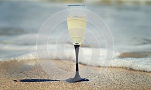 A glass of champagne by the sea.