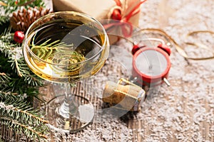 A glass of champagne sparkling wine cork clock close-up on a festive decorated table. Christmas New Year concept.