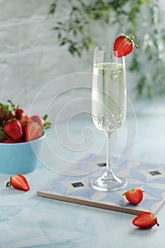 A glass of champagne with strawberries in summer style