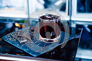 Glass of cherry juice with chocolate pieces