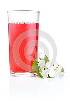 Glass of cherry juice and flowers