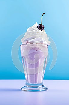 Glass of cherry milkshake with whipped cream.