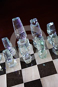 Glass chess pieces on board