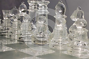 Glass chess pieces, Chess pieces arranged on a glass chess board