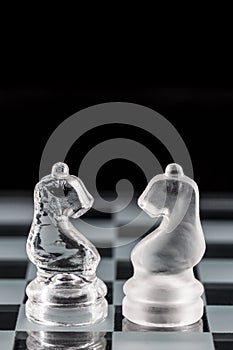 Glass chess pieces on a glass chessboard